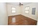 Bright bedroom featuring wood floors and natural light from two windows at 300 W Carr St, Mebane, NC 27302