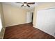 Bedroom with ceiling fan, wood floors and convenient double door closet at 300 W Carr St, Mebane, NC 27302