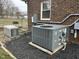 Outdoor generator and air conditioner unit installed on a modern brick home at 300 W Carr St, Mebane, NC 27302
