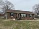 Charming brick home featuring a well-maintained yard and inviting entrance at 300 W Carr St, Mebane, NC 27302