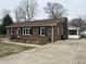 Charming brick home with a well-maintained yard and driveway at 300 W Carr St, Mebane, NC 27302