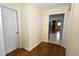 Hallway with hardwood floors leading to other rooms in the home at 300 W Carr St, Mebane, NC 27302