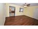 Spacious living room with wood floors offering a view to the kitchen area at 300 W Carr St, Mebane, NC 27302