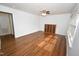 Open living room with hardwood floors and a charming display cabinet at 300 W Carr St, Mebane, NC 27302