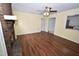 Cozy living room with a decorative brick fireplace, wooden flooring, and ceiling fan at 300 W Carr St, Mebane, NC 27302