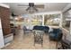 Cozy sunroom with tile flooring and ample seating, perfect for relaxation and entertaining at 300 W Carr St, Mebane, NC 27302