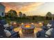 Outdoor fire pit area with stone surround and comfortable seating, perfect for entertaining guests and enjoying the serene view at 3215 Jones Lake Rd, Fuquay Varina, NC 27526