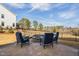 Inviting backyard features a stone fire pit, seating, and scenic views for outdoor gatherings at 3215 Jones Lake Rd, Fuquay Varina, NC 27526