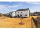 Large backyard features a stone fire pit area, screened porch, and green space at 3215 Jones Lake Rd, Fuquay Varina, NC 27526