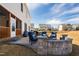 Backyard patio with a stone fire pit, comfortable seating, and a manicured lawn at 3215 Jones Lake Rd, Fuquay Varina, NC 27526