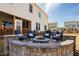 Backyard patio with a stone fire pit, comfortable seating, and a manicured lawn at 3215 Jones Lake Rd, Fuquay Varina, NC 27526