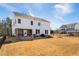 Spacious backyard showcases a stone fire pit, screened porch, and patio for outdoor enjoyment at 3215 Jones Lake Rd, Fuquay Varina, NC 27526
