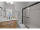 Bathroom with marble tile, glass shower, single vanity, and sink with neutral paint at 3215 Jones Lake Rd, Fuquay Varina, NC 27526