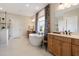 Bright bathroom featuring a soaking tub with stylish curtains, white countertops, and wood cabinets at 3215 Jones Lake Rd, Fuquay Varina, NC 27526