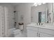 The bathroom has white cabinets, modern fixtures, and a shower with glass doors at 3215 Jones Lake Rd, Fuquay Varina, NC 27526