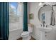 Charming powder room with a pedestal sink, round mirror, and stylish window covering at 3215 Jones Lake Rd, Fuquay Varina, NC 27526