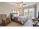 Cozy bedroom with a comfortable bed, ceiling fan, and a rocking chair at 3215 Jones Lake Rd, Fuquay Varina, NC 27526