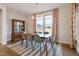 Bright dining room features a sleek table, modern chandelier, large window, and stylish decor at 3215 Jones Lake Rd, Fuquay Varina, NC 27526