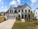 Charming two-story home with a two-car garage, well-manicured lawn, and inviting front porch at 3215 Jones Lake Rd, Fuquay Varina, NC 27526