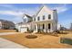Beautiful two-story home featuring a manicured lawn, attached garage, and classic white facade at 3215 Jones Lake Rd, Fuquay Varina, NC 27526