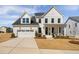 Charming two-story home with a well-manicured lawn, covered porch, and a two car garage at 3215 Jones Lake Rd, Fuquay Varina, NC 27526