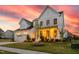 Beautiful home with a well-manicured lawn and a stunning sunset backdrop at 3215 Jones Lake Rd, Fuquay Varina, NC 27526