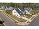 Stunning exterior view of a modern white home near a serene lake at 3215 Jones Lake Rd, Fuquay Varina, NC 27526