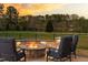 Enjoy the outdoor fire pit with stone surround, seating, and a fenced backyard at 3215 Jones Lake Rd, Fuquay Varina, NC 27526