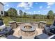 This outdoor fire pit features a stone surround, seating, and a fenced backyard at 3215 Jones Lake Rd, Fuquay Varina, NC 27526