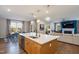 Open concept kitchen with island seating, dining area, and living room providing an inclusive space for entertaining at 3215 Jones Lake Rd, Fuquay Varina, NC 27526