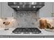 Gourmet kitchen with KitchenAid hood, marble backsplash, and a professional gas range at 3215 Jones Lake Rd, Fuquay Varina, NC 27526