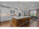 Spacious kitchen island with pendant lights, white cabinets, and modern appliances at 3215 Jones Lake Rd, Fuquay Varina, NC 27526