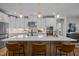 Modern kitchen island featuring pendant lighting, bar seating, and sleek countertop at 3215 Jones Lake Rd, Fuquay Varina, NC 27526