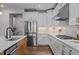 Bright kitchen featuring stainless steel appliances, white cabinets, and open design at 3215 Jones Lake Rd, Fuquay Varina, NC 27526