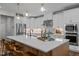 Bright kitchen features a large island, pendant lighting, stainless steel appliances, and marble backsplash at 3215 Jones Lake Rd, Fuquay Varina, NC 27526