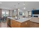 Open-concept kitchen with central island, white countertops, and seamless living area access at 3215 Jones Lake Rd, Fuquay Varina, NC 27526