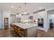 Spacious kitchen featuring a large island with seating, stainless appliances and elegant pendant lighting at 3215 Jones Lake Rd, Fuquay Varina, NC 27526