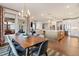 Open concept kitchen and dining area with modern lighting, stainless appliances, and a view into the living room at 3215 Jones Lake Rd, Fuquay Varina, NC 27526