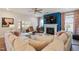 Bright living room features a fireplace, stylish ceiling fan and comfortable, oversized sectional sofa for relaxing at 3215 Jones Lake Rd, Fuquay Varina, NC 27526