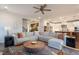 Open concept living room with a large sectional sofa and a view into the modern kitchen at 3215 Jones Lake Rd, Fuquay Varina, NC 27526
