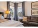 Bright and inviting main bedroom with lake views, a perfect spot for reading or relaxing with view of the water at 3215 Jones Lake Rd, Fuquay Varina, NC 27526