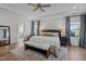 Spacious main bedroom featuring tray ceiling, ceiling fan and bench at the foot of the bed at 3215 Jones Lake Rd, Fuquay Varina, NC 27526