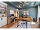 Stylish home office with built-in shelving, a spacious desk, and a comfortable seating area at 3215 Jones Lake Rd, Fuquay Varina, NC 27526