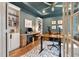 Stylish home office with built-in shelving, a spacious desk, and a comfortable seating area at 3215 Jones Lake Rd, Fuquay Varina, NC 27526