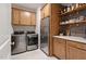 Efficient pantry with stainless steel refrigerator and extra cabinetry storage at 3215 Jones Lake Rd, Fuquay Varina, NC 27526