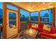 The screened-in patio has a sectional sofa, a lit fire pit, and ample seating at 3215 Jones Lake Rd, Fuquay Varina, NC 27526