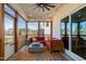 Inviting screened porch with comfortable seating, an outdoor fan, and scenic views at 3215 Jones Lake Rd, Fuquay Varina, NC 27526
