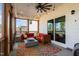 Screened porch featuring a large seating area with outdoor ceiling fan and stylish floral rug at 3215 Jones Lake Rd, Fuquay Varina, NC 27526