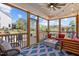 Relaxing screened porch with a fire pit, comfortable seating, wooded views, and ceiling fan at 3215 Jones Lake Rd, Fuquay Varina, NC 27526