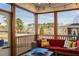 Inviting screened porch with comfortable seating and scenic backyard views of trees and a lake at 3215 Jones Lake Rd, Fuquay Varina, NC 27526